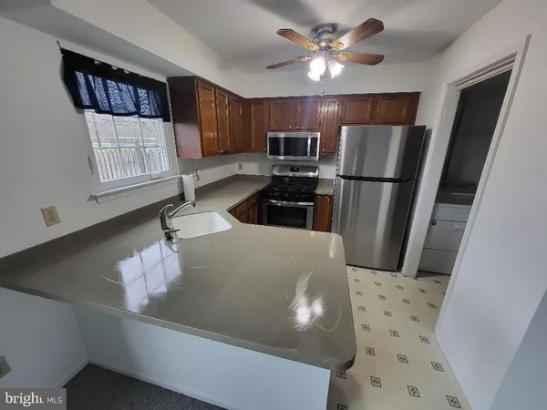 a spacious bedroom with a bed a couch and dresser