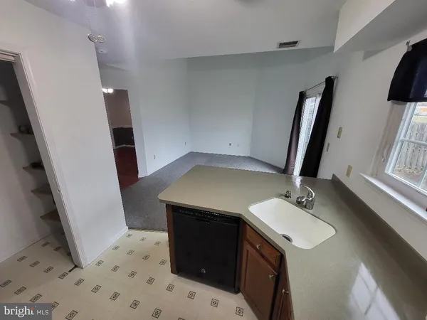 a white toilet next to a bathroom