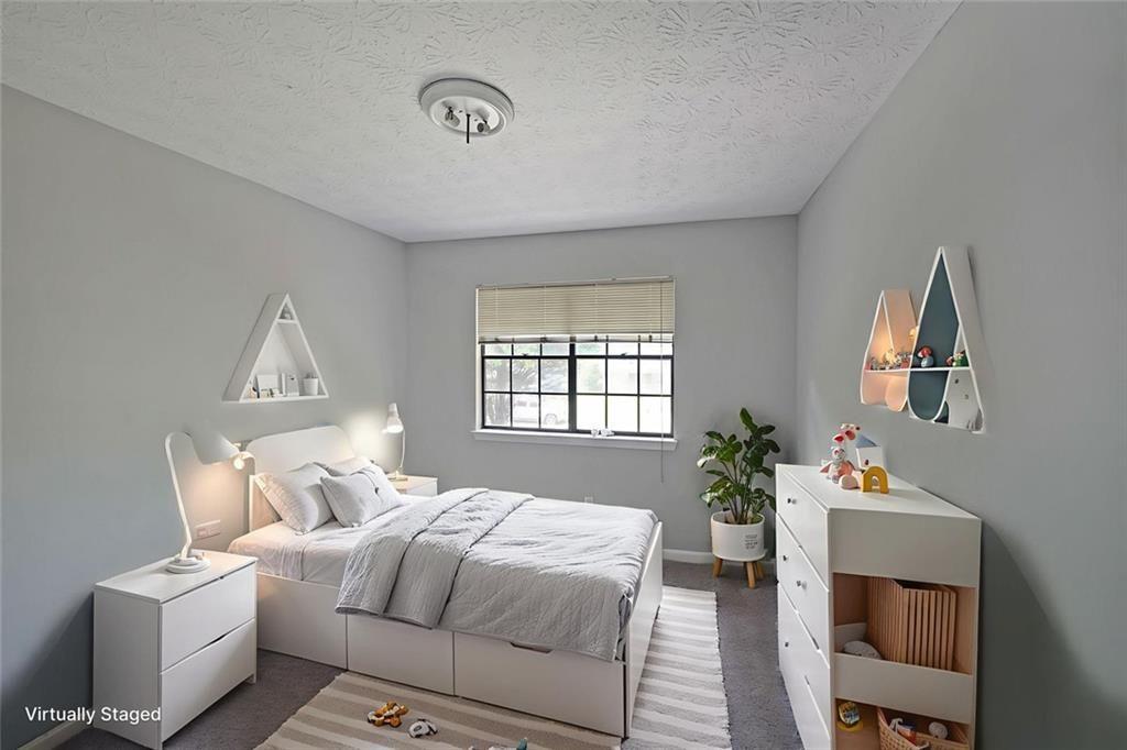 3087 Drexel Lane Rex, GA 30273 - Photo 18 of 22 a bedroom with bed table and window