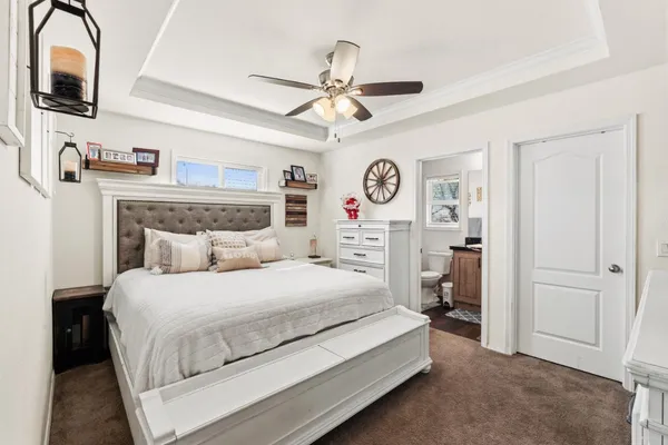 a bedroom with a bed and a chandelier