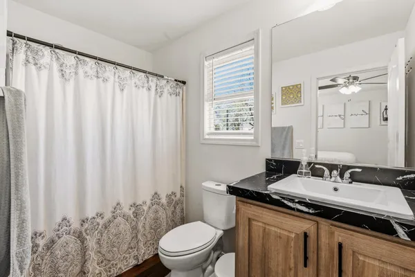 a bathroom with a sink toilet and shower