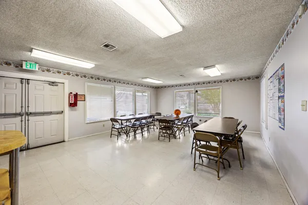 a view of a dining room with furniture and a chandelier