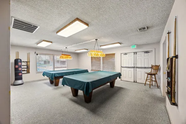 a room with pool table and furniture