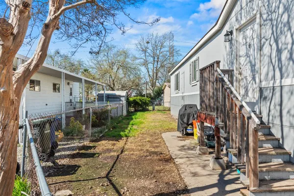 a view of a house with backyard and sitting area
