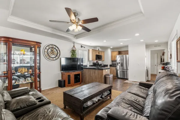 a living room with furniture and a wooden floor