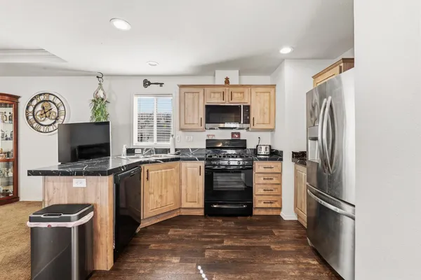 a kitchen with stainless steel appliances a stove microwave and a refrigerator