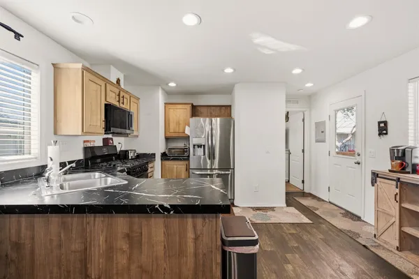 a kitchen with refrigerator and sink