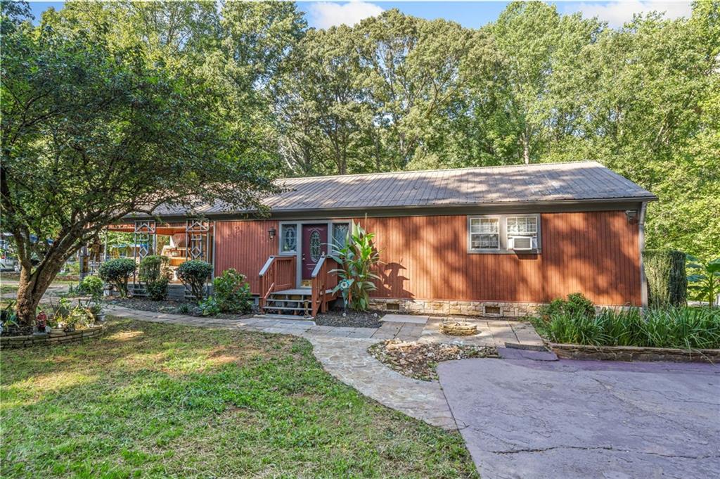 3230 Kelly Bridge Road Dawsonville, GA 30534 - Photo 1 of 1 a backyard of a house with yard barbeque oven and outdoor seating