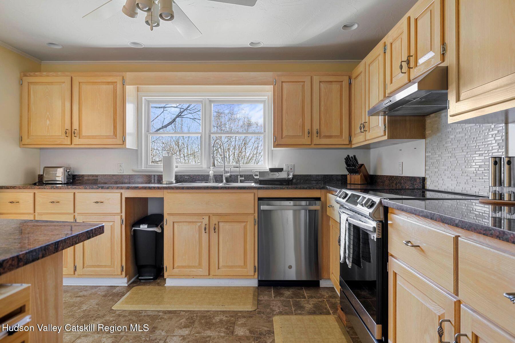 78 Buckskin Loop Windham, NY 12496 - Photo 13 of 97 a kitchen with granite countertop a sink stainless steel appliances and cabinets