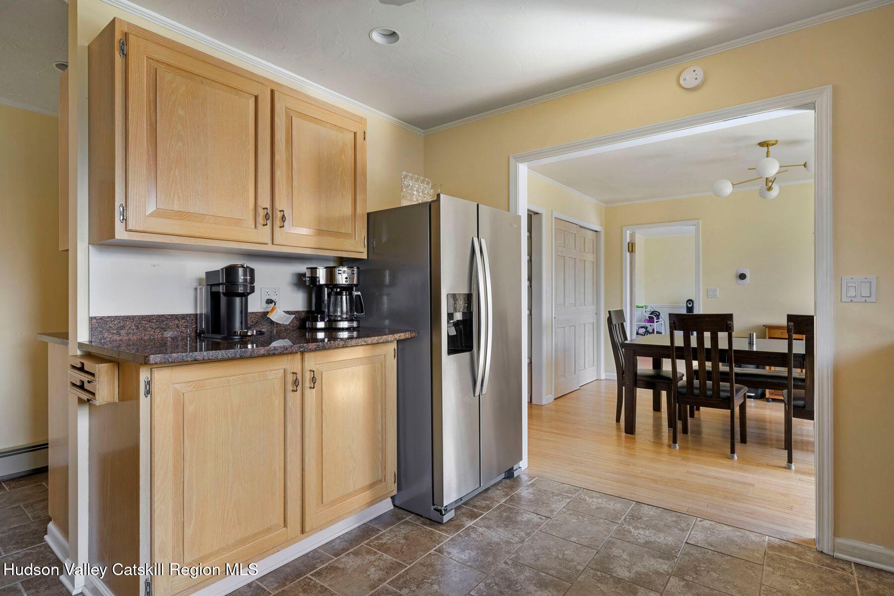78 Buckskin Loop Windham, NY 12496 - Photo 15 of 97 a kitchen with stainless steel appliances granite countertop a refrigerator a stove a dining table and chairs