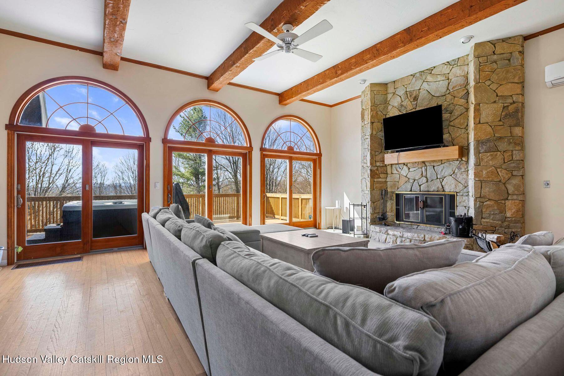 78 Buckskin Loop Windham, NY 12496 - Photo 3 of 97 a living room with furniture a fireplace and floor to ceiling windows