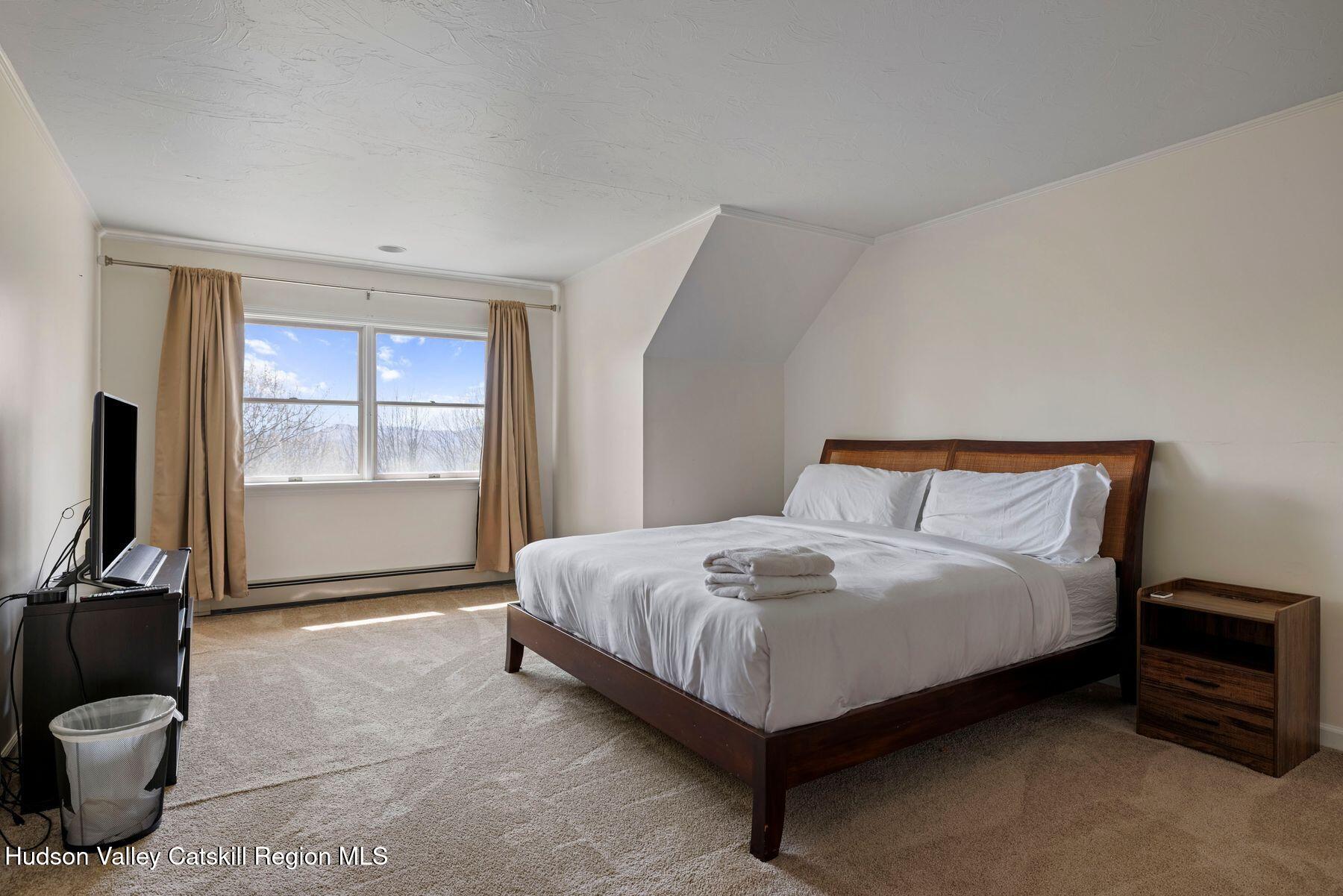 78 Buckskin Loop Windham, NY 12496 - Photo 48 of 97 a bedroom with a bed and a flat tv screen on the dresser