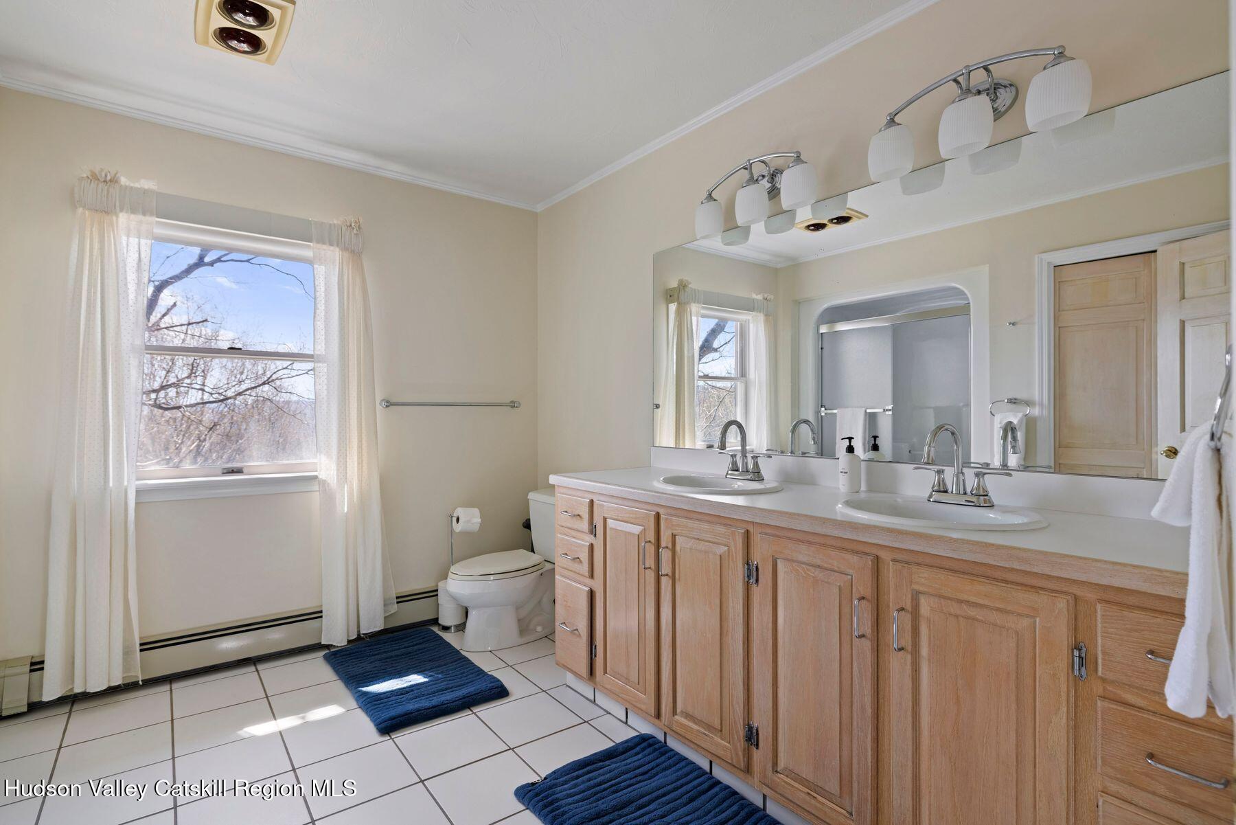 78 Buckskin Loop Windham, NY 12496 - Photo 51 of 97 a spacious bathroom with a double vanity sink a toilet and a mirror