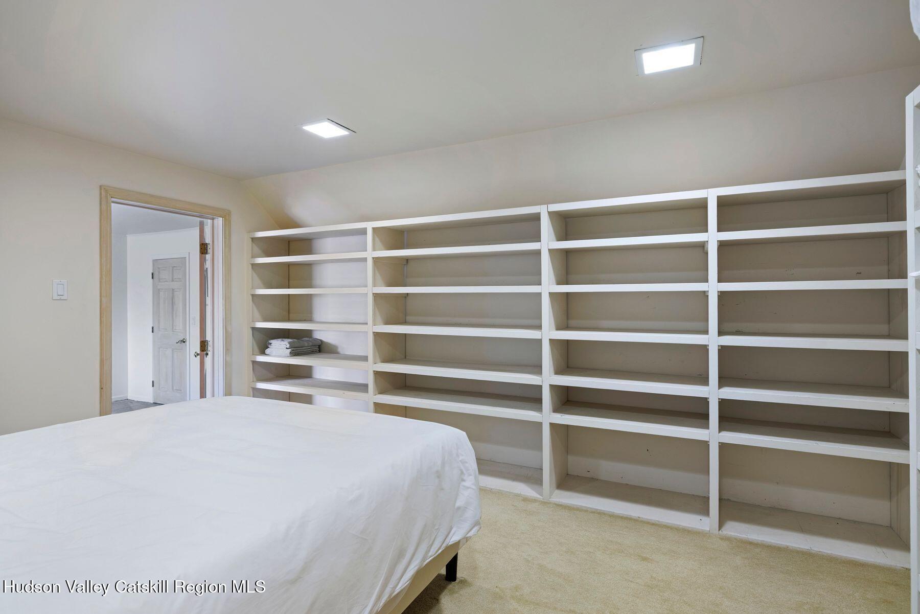 78 Buckskin Loop Windham, NY 12496 - Photo 58 of 97 a large white bed in a bedroom next to a cabinet and a window