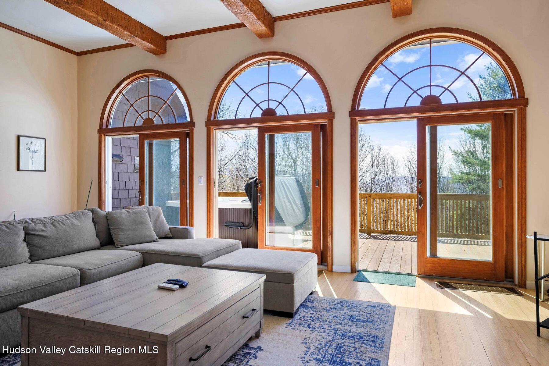 78 Buckskin Loop Windham, NY 12496 - Photo 6 of 97 a living room with furniture and two large window
