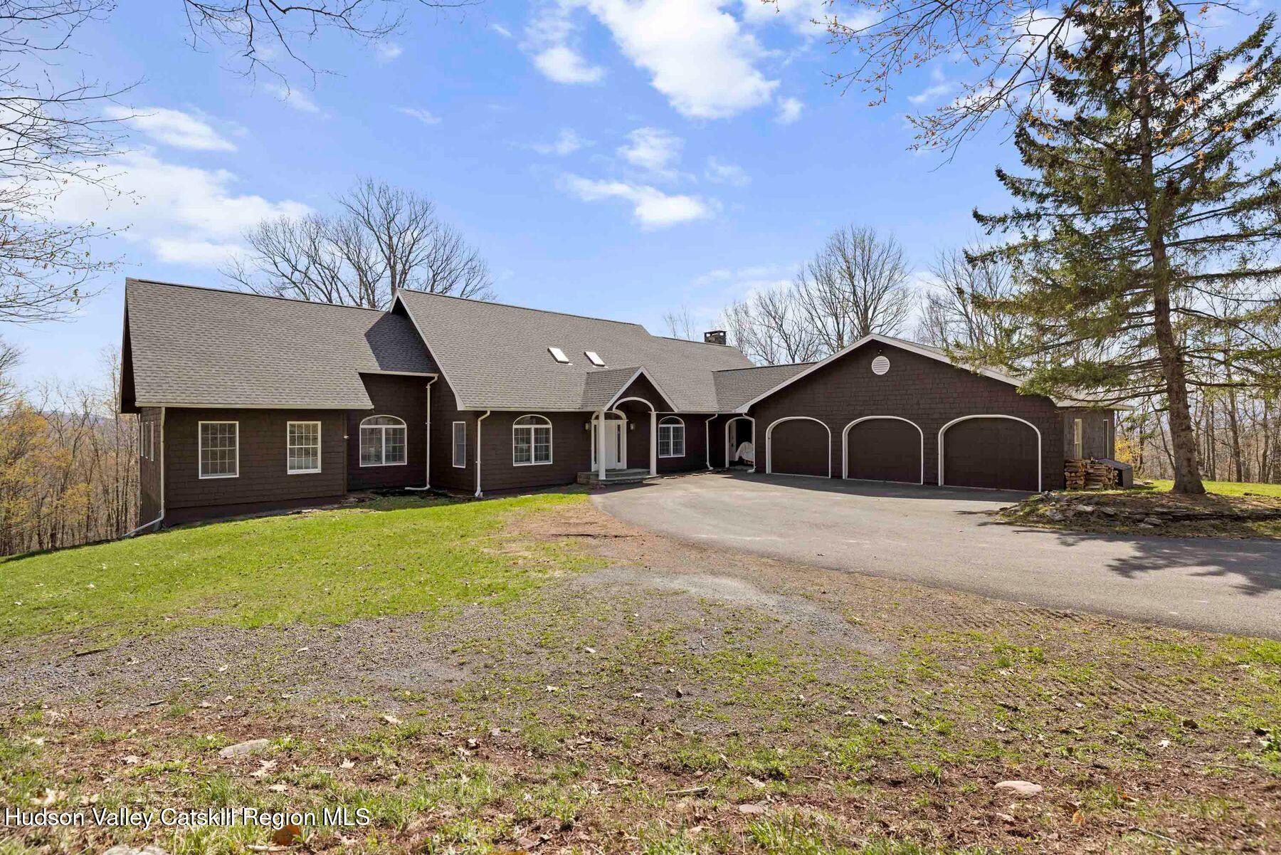 78 Buckskin Loop Windham, NY 12496 - Photo 78 of 97 a front view of a house with a yard and garage