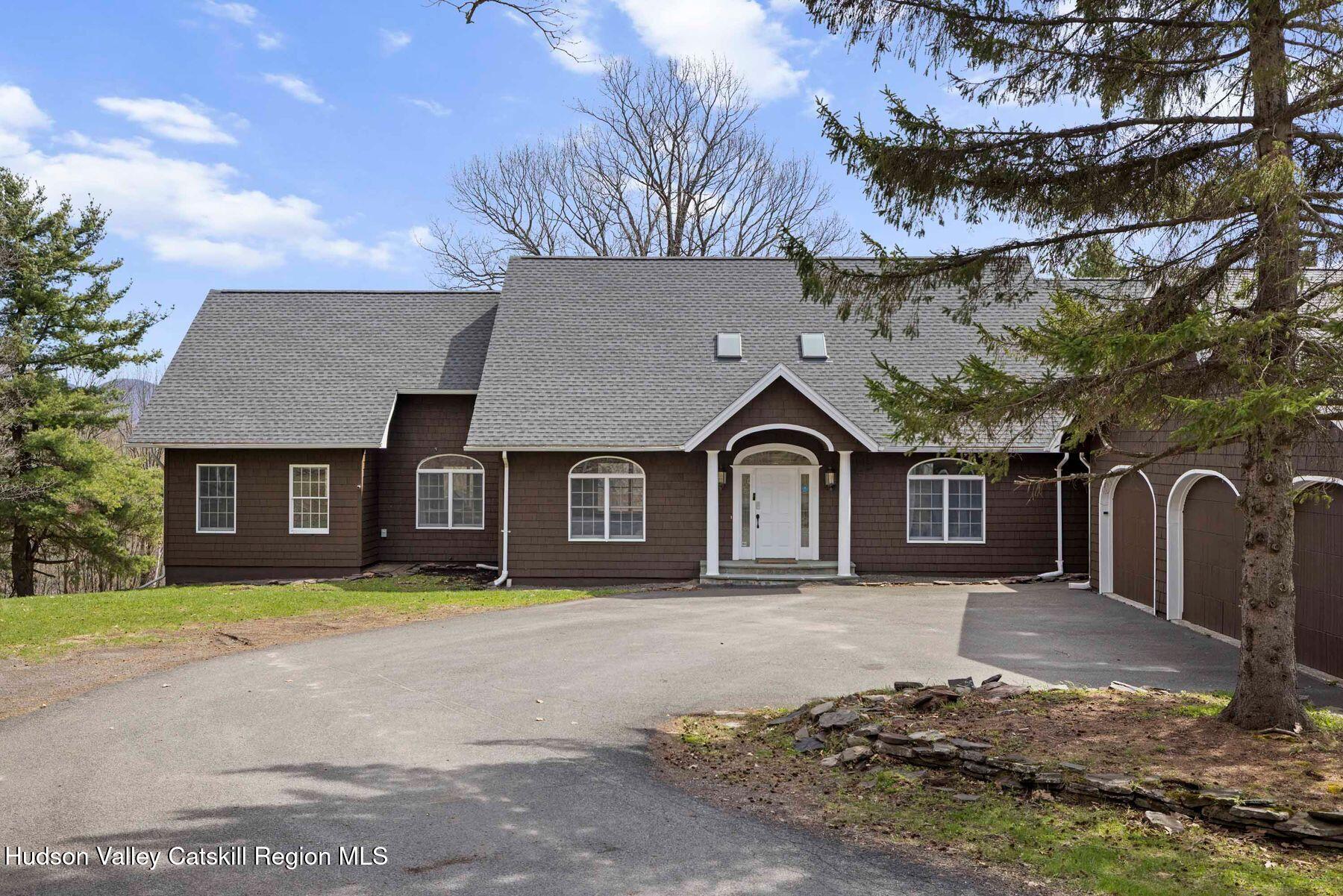 78 Buckskin Loop Windham, NY 12496 - Photo 79 of 97 a front view of a house with a yard and garage