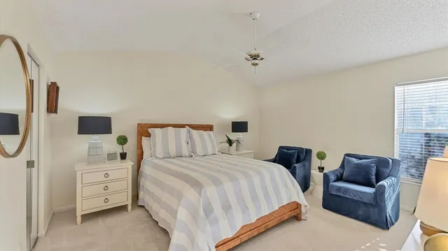 a bedroom with a bed a couch and dresser