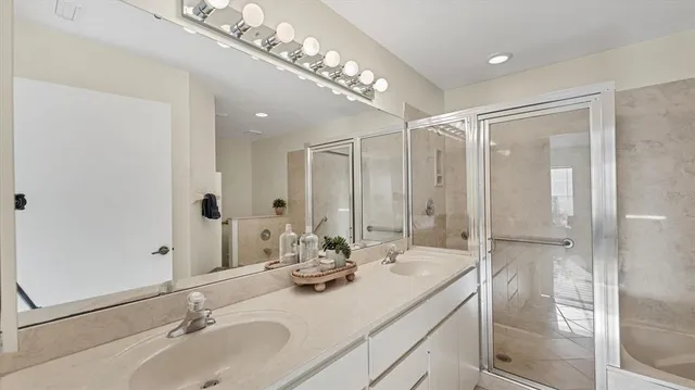 a bathroom with a double vanity sink and a mirror