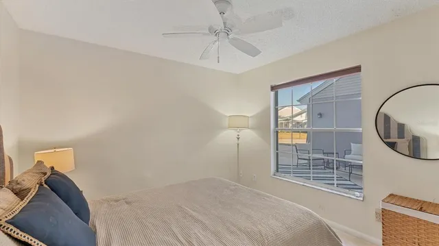 a bedroom with a large bed and a chandelier