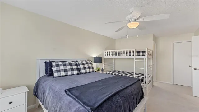 a bed sitting in a bedroom next to a window