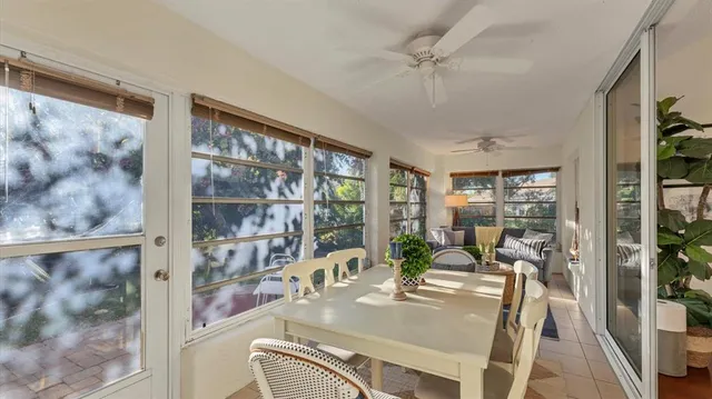 a view of a dining room with furniture large windows and wooden floor