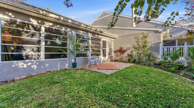 a view of an house with backyard porch and sitting area