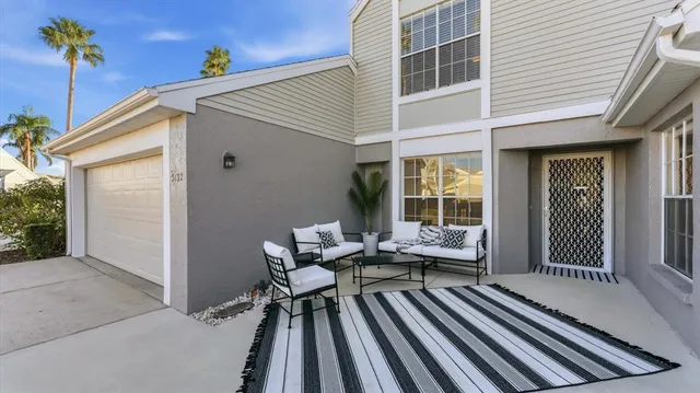 a balcony with with furniture and a potted plant