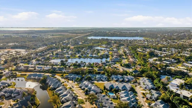 a view of a house with swimming pool and sitting area