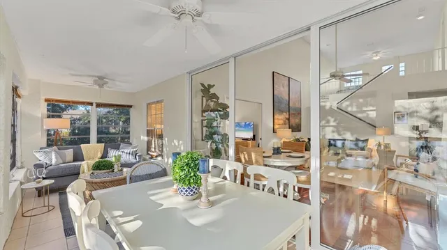 a dining room with furniture a chandelier and wooden floor