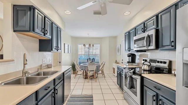 a kitchen with a sink cabinets and stainless steel appliances