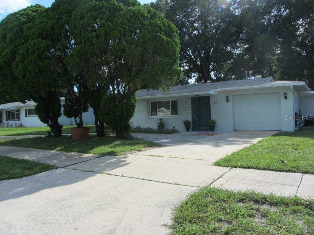 1092 Keene Road Largo, FL 33771 - Photo 1 of 1 1 car garage with circular driveway for plenty of parking and easy access in and out of this home.