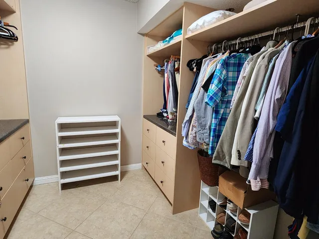 a bathroom with a granite countertop sink a toilet and bathtub