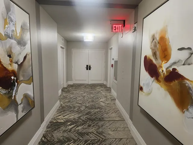 a view of staircase with wooden floor and mirror