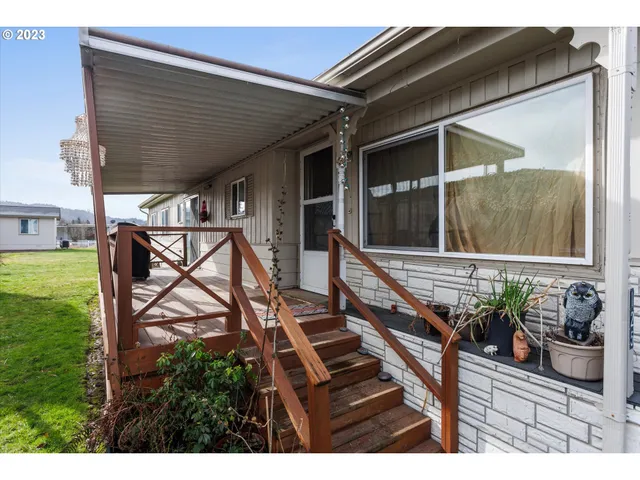 a view of a house with backyard and deck