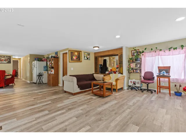 a living room with furniture and a dining table