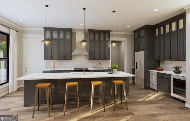 a kitchen with kitchen island granite countertop a table chairs refrigerator and microwave