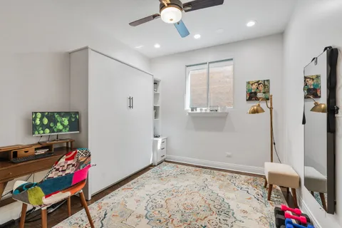 a bedroom with a bed a desk and chair