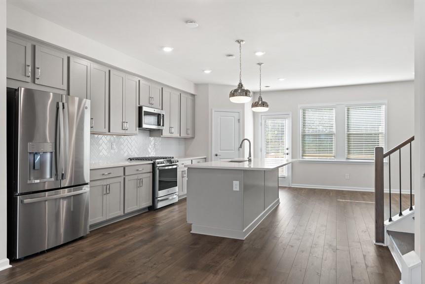 1604 Halbrook Place Southwest Marietta, GA 30008 - Photo 1 of 1 a kitchen with kitchen island granite countertop stainless steel appliances cabinets a sink and a wooden floor