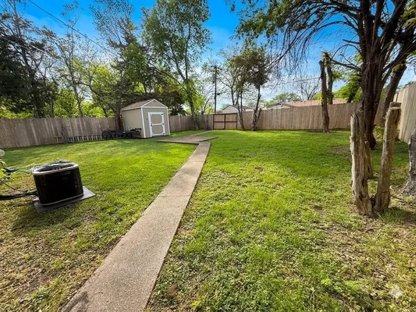 a view of a backyard with large trees