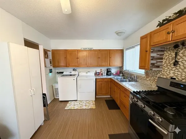 a kitchen with a sink stove and refrigerator