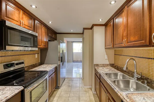 a kitchen that has a sink and a stove