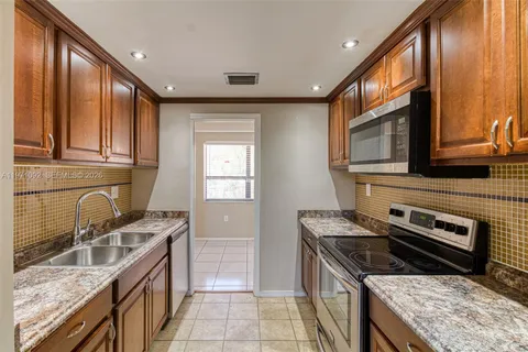 a kitchen with a stove sink and microwave