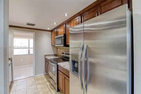 a kitchen with a refrigerator and a sink