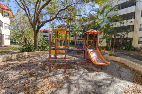 a view of a park with swings and slides