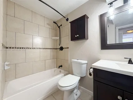 a bathroom with a sink a toilet and a bathtub