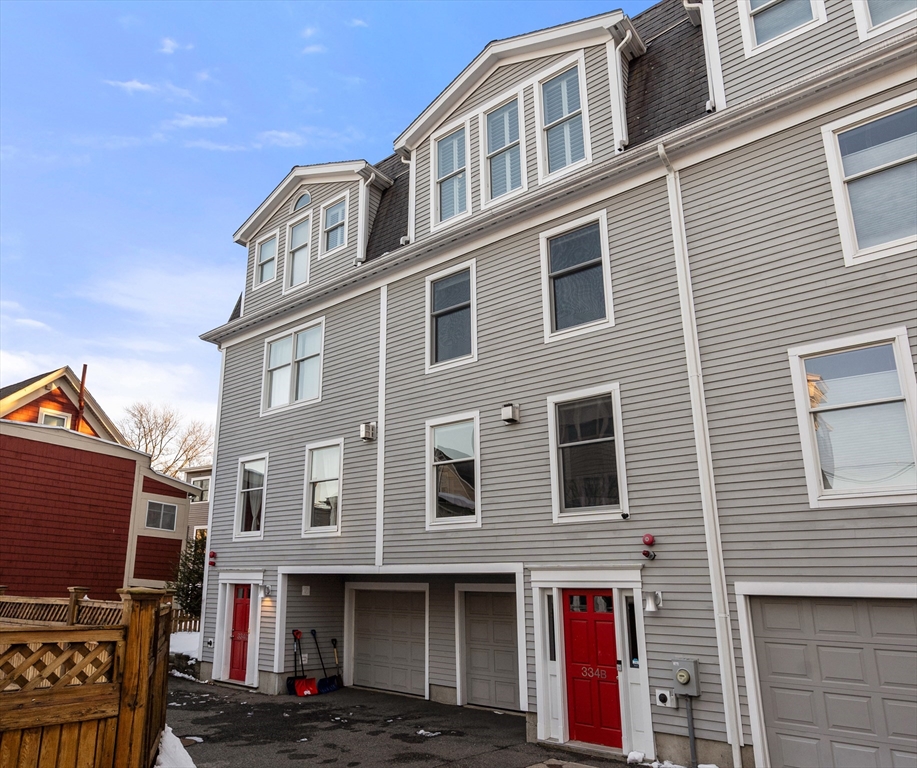 334 Beacon Street, Unit B Somerville, MA 02143 - Photo 1 of 23 a front view of a building with many windows