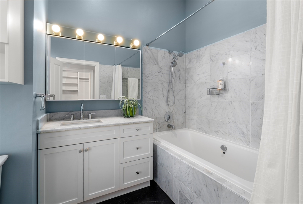 334 Beacon Street, Unit B Somerville, MA 02143 - Photo 15 of 23 a bathroom with a tub sink and mirror