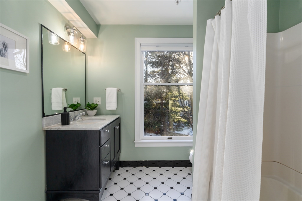 334 Beacon Street, Unit B Somerville, MA 02143 - Photo 18 of 23 a bathroom with a sink a mirror and a shower