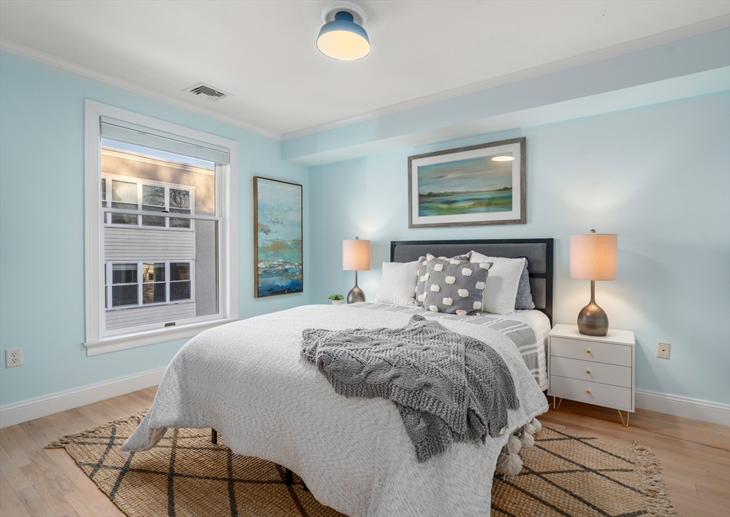 334 Beacon Street, Unit B Somerville, MA 02143 - Photo 19 of 23 a bedroom with a bed and a window